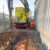Vac-Ex vacuum excavator operating beside industrial building, removing soil safely around buried utilities during precision excavation